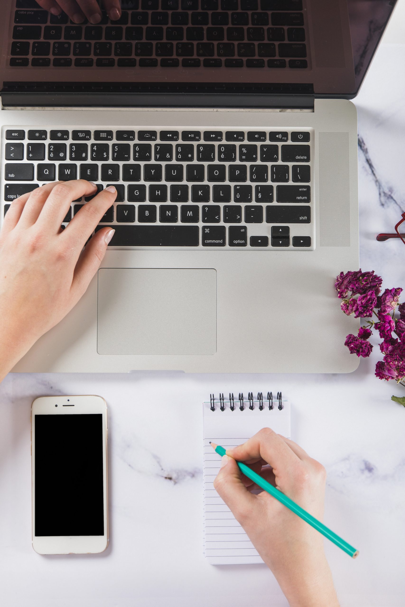 crop-hands-using-laptop-making-notes